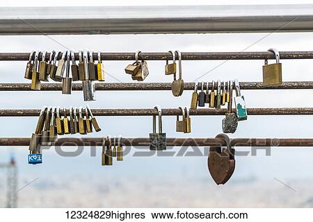 Stock Photograph - Some padlocks on the handrail, Montjuic; Barcelona, Catalonia, Spain. Fotosearch