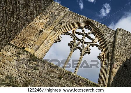 Stone facade and decorative window of a ruined building; North Yorkshire, England View Large Photo Image Stock Photograph - Stone facade and decorative window of a ruined building; North Yorkshire, England. Fotosearch