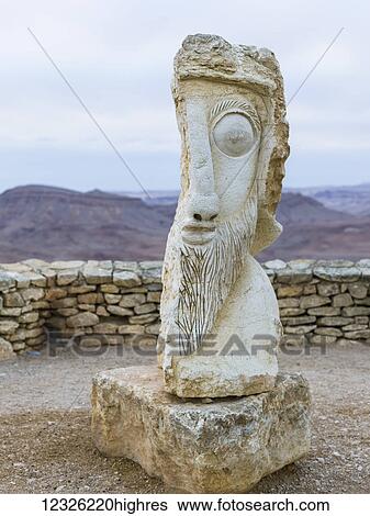 Stock Photograph - Stone sculpture of a face in male likeness; Mitzpe Ramon, South District, Israel. Fotosearch
