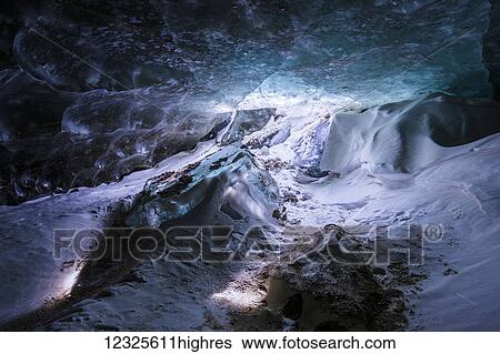 Strange light shines on the floor of a cave beneath the ice of Castner Glacier in the Alaska Range; Alaska, United States of America View Large Photo Image Stock Photograph - Strange light shines on the floor of a cave beneath the ice of Castner Glacier in the Alaska Range; Alaska, United States of America. Fotosearch