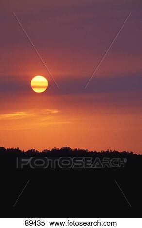 Sun setting on hazy day View Large Photo Image Stock Photography - Sun setting on hazy day. Fotosearch