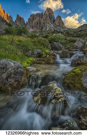 Stock Photograph - Sunrise over a mountain stream in the Italian Dolomites; Cortina, Italy. Fotosearch