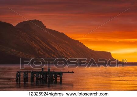Stock Photograph - Sunrise over the waters near Djupavik, Strandir Coast; West Fjords, Iceland. Fotosearch