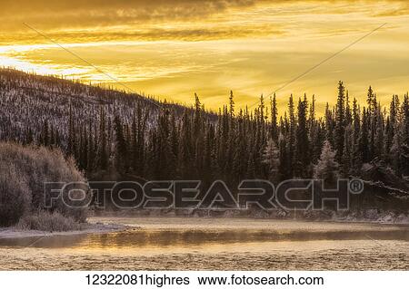 Stock Photograph - Sunrise over top of the Fishing Branch River in Ni'iinlii Njik (Fishing Branch) Territorial Park; Yukon, Canada. Fotosearch