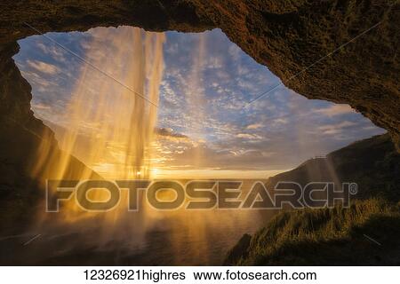 Sunset light shines through the water of Seljandefoss along the South coast; Iceland View Large Photo Image Stock Photograph - Sunset light shines through the water of Seljandefoss along the South coast; Iceland. Fotosearch