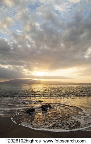 Stock Photograph - Sunset over Lanai Isle; Lahaina, Maui, Hawaii, United States of America. Fotosearch