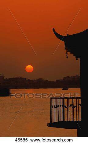 Sunset over river with silhouette of pagoda roof View Large Photo Image Stock Photography - Sunset over river with silhouette of pagoda roof. Fotosearch