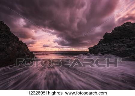 Stock Photograph - Sunset over the beach called Djupalonsandur which on the western tip of the Snaefellsness Peninsula; Iceland. Fotosearch