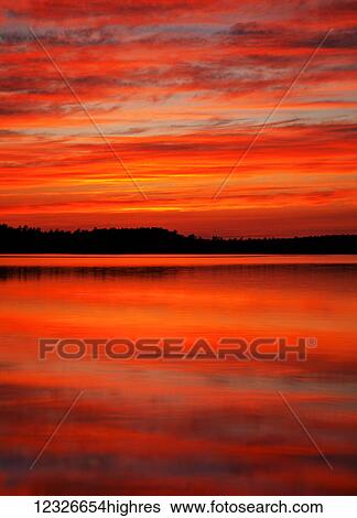 Stock Photograph - Sunset reflections at Powder Mill Lake; Waverley, Nova Scotia, Canada. Fotosearch