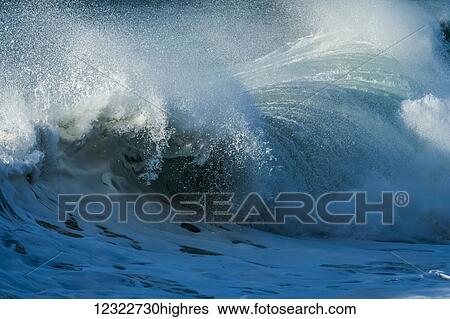 Stock Photograph - Surf breaks near the shore; Oregon, United States of America. Fotosearch