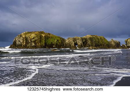 Stock Photograph - Surf comes ashore at Bandon Beach; Bandon, Oregon, United States of America. Fotosearch