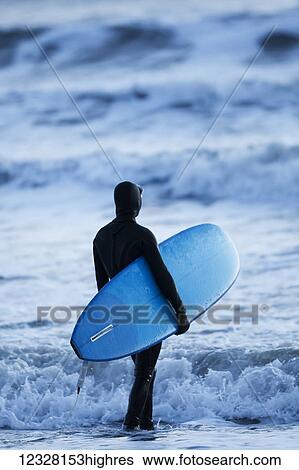 Surfer standing with board at the edge of the water, Homer Spit, Kachemak Bay, Kenai Peninsula, Southcentral Alaska, USA View Large Photo Image Stock Photograph - Surfer standing with board at the edge of the water, Homer Spit, Kachemak Bay, Kenai Peninsula, Southcentral Alaska, USA. Fotosearch