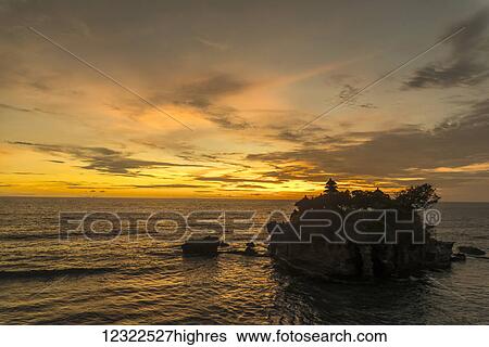 Stock Photograph - Tanah Lot temple with a golden sunset; Bali I. Fotosearch