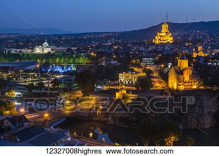 Stock Photograph - Tbilisi at night, the capital and the largest city of Georgia with Sameba (Holy Trinity Cathedral of Tbilisi); Tbilisi, Georgia. Fotosearch