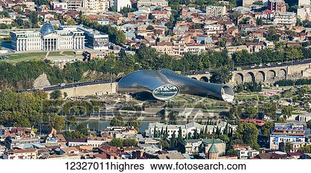Stock Photograph - Tbilisi, the capital and the largest city of Georgia, with the tubular concert hall building; Tbilisi, Georgia. Fotosearch