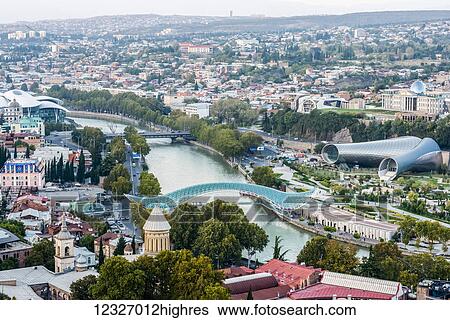 Tbilisi, the capital and the largest city of Georgia, with Bridge of Peace, tubular concert hall building and mushroom-like Justice House; Tbilisi, Georgia View Large Photo Image Stock Photograph - Tbilisi, the capital and the largest city of Georgia, with Bridge of Peace, tubular concert hall building and mushroom-like Justice House; Tbilisi, Georgia. Fotosearch