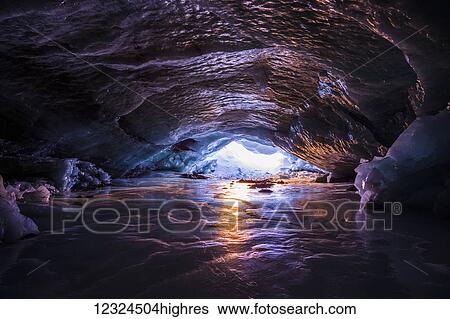 The colors of sunset reflect off the ice inside an ice cave within Augustana Glacier in the Alaska Range in winter; Alaska, United States of America View Large Photo Image Stock Photograph - The colors of sunset reflect off the ice inside an ice cave within Augustana Glacier in the Alaska Range in winter; Alaska, United States of America. Fotosearch
