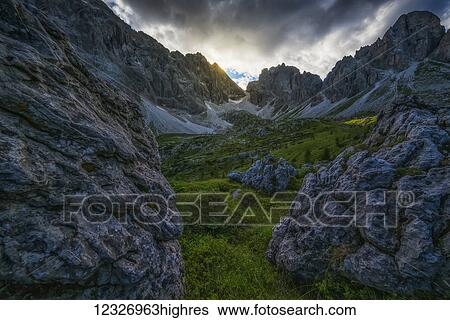 Stock Photograph - The Dolomite mountains at dusk; Cortina, Italy. Fotosearch