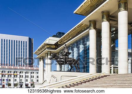 Stock Photograph - The Mongolian Parliament building is on the west side of Chinggis Khaan Square, two equestrian statues which flank the statue of Chinggis Khaan, depicting Khaan's guard Bo'orchu. There are also statues of Ogedei Khaan and Kublai Khaan on either side.... Fotosearch