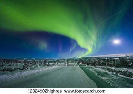 The moon and aurora shine in the night sky over a snow covered Richardson Highway south of Delta Junction; Alaska, United States of America View Large Photo Image Stock Photograph - The moon and aurora shine in the night sky over a snow covered Richardson Highway south of Delta Junction; Alaska, United States of America. Fotosearch