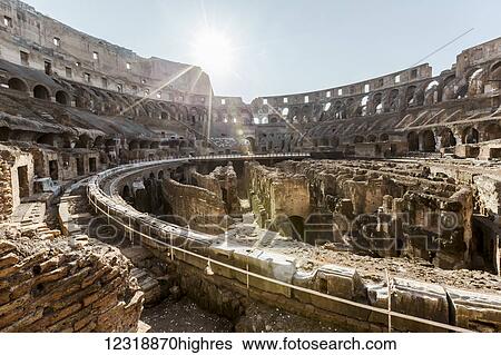 The morning sun shines just above the walls of the colosseum early in the morning with 0 tourists yet visiting; Rome, Italy View Large Photo Image Stock Photograph - The morning sun shines just above the walls of the colosseum early in the morning with 0 tourists yet visiting; Rome, Italy. Fotosearch