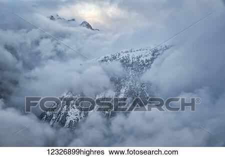 The mountains of Golden Ears Provincial Park are shrouded in clouds in the aerial photo; British Columbia, Canada View Large Photo Image Stock Photograph - The mountains of Golden Ears Provincial Park are shrouded in clouds in the aerial photo; British Columbia, Canada. Fotosearch