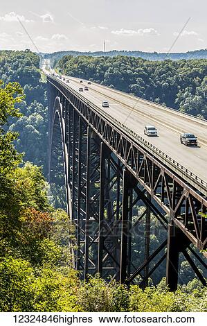 Stock Photograph - The New River Gorge Bridge, a steel arch bridge 3, 030 feet long over the New River Gorge near Fayetteville in the Appalachian Mountains of the eastern United States; West Virginia, United States of America. Fotosearch