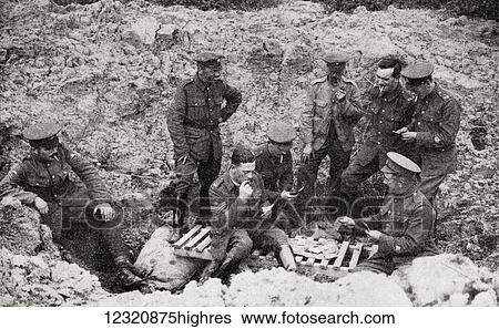 Stock Photograph - The Opportunists. Warrant Officers and N. C. O. 's playing cards in a shell hole in 1917. From the magazine Twenty Years After The Battlefields of 1914-1918 Then and Now by Sir Ernest Swinton published 1938.. Fotosearch