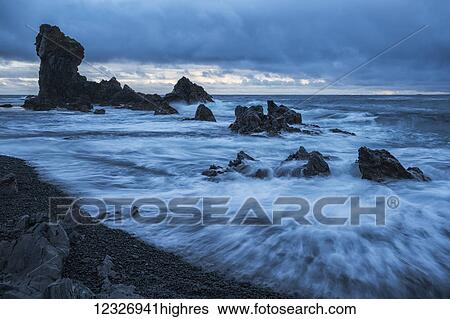 Stock Photograph - The pounding surf on the beach of Djupalon which is on the western tip of the Snaefellsness Peninsula; Iceland. Fotosearch