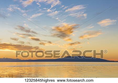 The setting sun silhouettes Mount Susitna, seen from Earthquake Park, South-central Alaska; Anchorage, Alaska, United States of America View Large Photo Image Stock Photograph - The setting sun silhouettes Mount Susitna, seen from Earthquake Park, South-central Alaska; Anchorage, Alaska, United States of America. Fotosearch