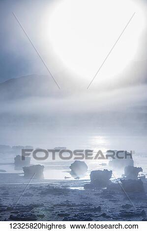The sun shines through low altitude fog along Turnagain Arm and the Seward Highway in winter, sea ice covering the ocean in the foreground, the Chugach Moutains revealed in the background, South-central Alaska; Alaska, United States of America View Large Photo Image Stock Photograph - The sun shines through low altitude fog along Turnagain Arm and the Seward Highway in winter, sea ice covering the ocean in the foreground, the Chugach Moutains revealed in the background, South-central Alaska; Alaska, United States of America. Fotosearch