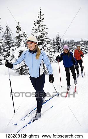 Stock Photograph - Three young women cross country skiing, Ohlson Mountain; Alaska, United States of America. Fotosearch