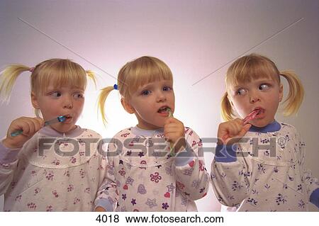 Triplets brushing teeth View Large Photo Image Stock Photo - Triplets brushing teeth. Fotosearch