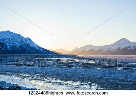 Stock Photograph - Turnagain Arm just before sunrise on an icy winter morning along the Seward Highway; Alaska, United States of America. Fotosearch