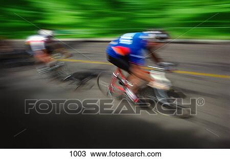 Two cyclists racing on road View Large Photo Image Stock Image - Two cyclists racing on road. Fotosearch