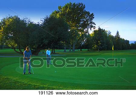 Two golfers on green View Large Photo Image Stock Photograph - Two golfers on green. Fotosearch