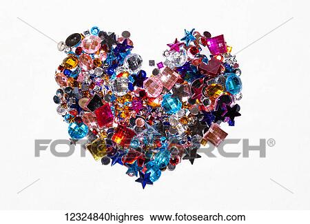 Variety of colourful beads in the shape of a heart on a white background; Ontario, Canada View Large Photo Image Stock Photograph - Variety of colourful beads in the shape of a heart on a white background; Ontario, Canada. Fotosearch