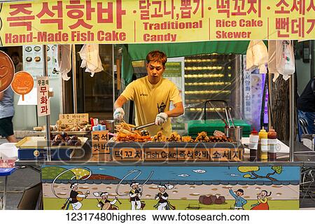Stock Photograph - Vendor preparing food at a food stall; Seoul, South Korea. Fotosearch