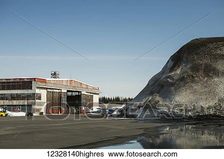View of a hangar and a pile of snow at the Yakutat airport, Southeast Alaska, USA View Large Photo Image Stock Photograph - View of a hangar and a pile of snow at the Yakutat airport, Southeast Alaska, USA. Fotosearch