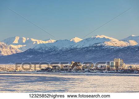 View of downtown Anchorage in winter and the snow-capped Chugach Mountains beyond seen from Point MacKenzie, the skies in the background clear and bright, sea ice covering Cook Inlet in the foreground, South-central Alaska; Anchorage, Alaska, United... View Large Photo Image Stock Photograph - View of downtown Anchorage in winter and the snow-capped Chugach Mountains beyond seen from Point MacKenzie, the skies in the background clear and bright, sea ice covering Cook Inlet in the foreground, South-central Alaska; Anchorage, Alaska, United.... Fotosearch