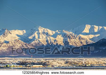 View of downtown Anchorage in winter and the snow-capped Chugach Mountains beyond seen from Point MacKenzie, the skies in the background clear and bright, sea ice covering Cook Inlet in the foreground, South-central Alaska; Anchorage, Alaska, United... View Large Photo Image Stock Photograph - View of downtown Anchorage in winter and the snow-capped Chugach Mountains beyond seen from Point MacKenzie, the skies in the background clear and bright, sea ice covering Cook Inlet in the foreground, South-central Alaska; Anchorage, Alaska, United.... Fotosearch