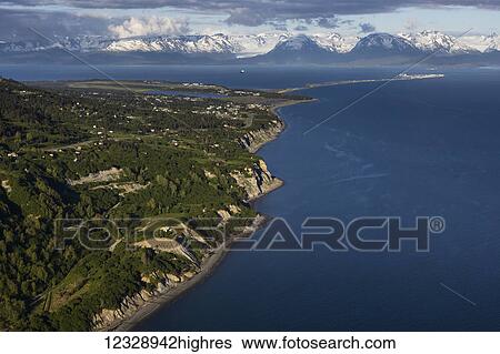 Stock Photograph - View of the shoreline of Kachemak Bay with the Kenai Mountains in the distance; Homer, Alaska, United States of America. Fotosearch