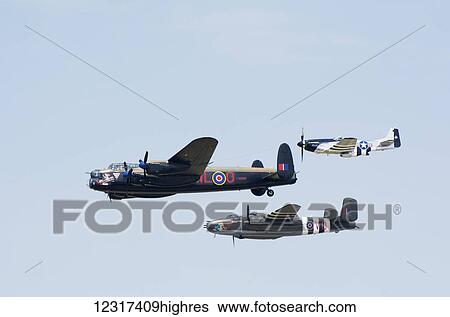 Stock Photograph - Vintage aircraft flying in formation; Edmonton, Alberta, Canada. Fotosearch