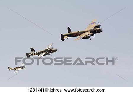 Stock Photograph - Vintage aircraft flying in formation; Edmonton, Alberta, Canada. Fotosearch