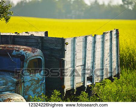 Stock Photograph - Vintage delivery truck sitting parked and abandoned on the edge of a farm field; Alberta, Canada. Fotosearch