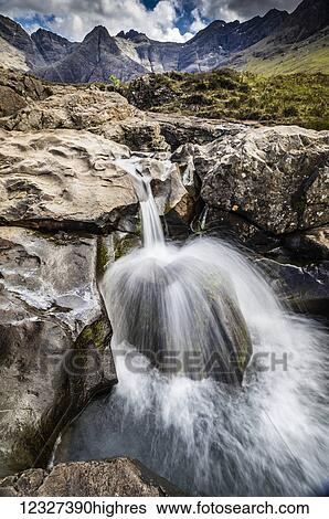 Stock Photograph - Water splashing over rock at Fairy Pools; Glenn Brittle, Isle of Skye, Scotland. Fotosearch