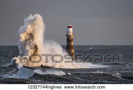 Waves splashing against Roker lighthouse at the end of a pier; Sunderland, Tyne and Wear, England View Large Photo Image Stock Photograph - Waves splashing against Roker lighthouse at the end of a pier; Sunderland, Tyne and Wear, England. Fotosearch