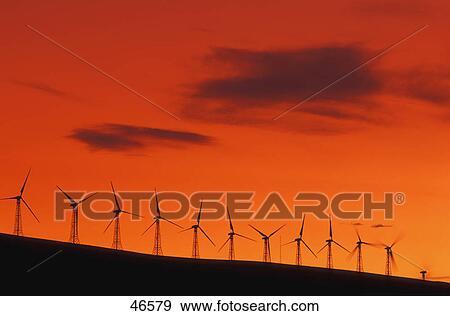 Stock Photo - Wind generators on crest of hill. Fotosearch