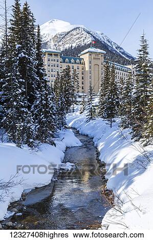 Winter trails along Lake Louise in Banff National Park, the river is not fully frozen at the edge of the Fairmont Chateau Lake Louise Resort shown against the mountains in the background; Lake Louise, Alberta, Canada View Large Photo Image Stock Photograph - Winter trails along Lake Louise in Banff National Park, the river is not fully frozen at the edge of the Fairmont Chateau Lake Louise Resort shown against the mountains in the background; Lake Louise, Alberta, Canada. Fotosearch