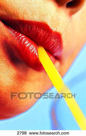 Woman drinking through a straw View Large Photo Image Stock Photo - Woman drinking through a straw. Fotosearch